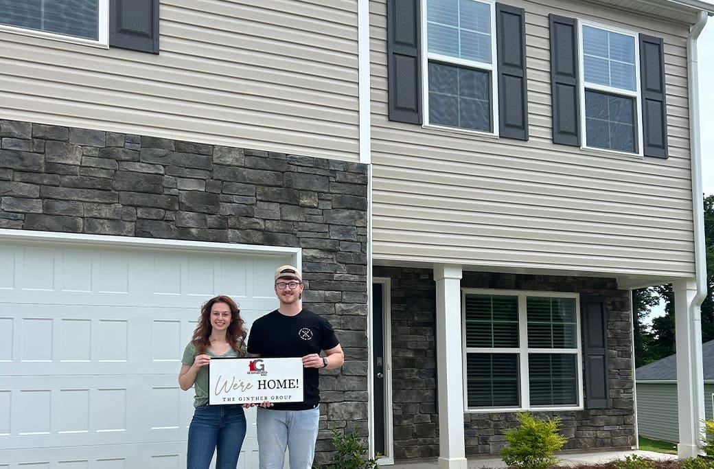 Happy homeowners celebrating the successful purchase of a Clemmons home with The Ginther Group