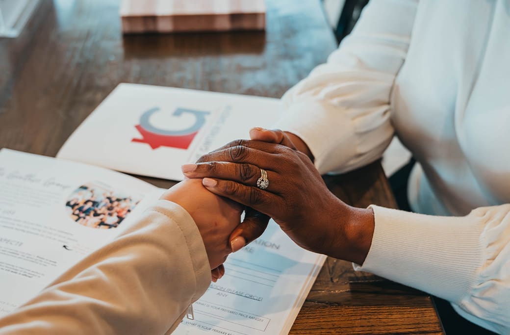 The Ginther Group branding with a handshake representing trusted real estate guidance for Winston-Salem home buyers